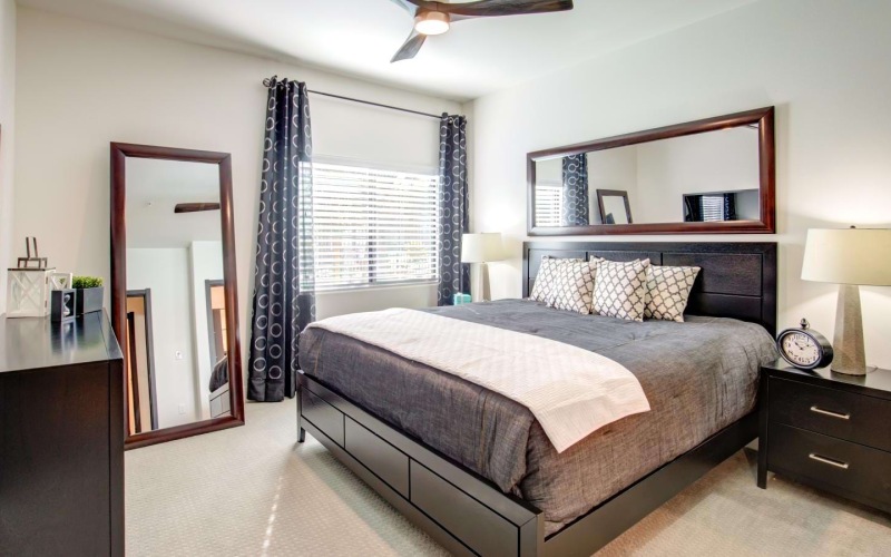 carpeted bedroom with large windows